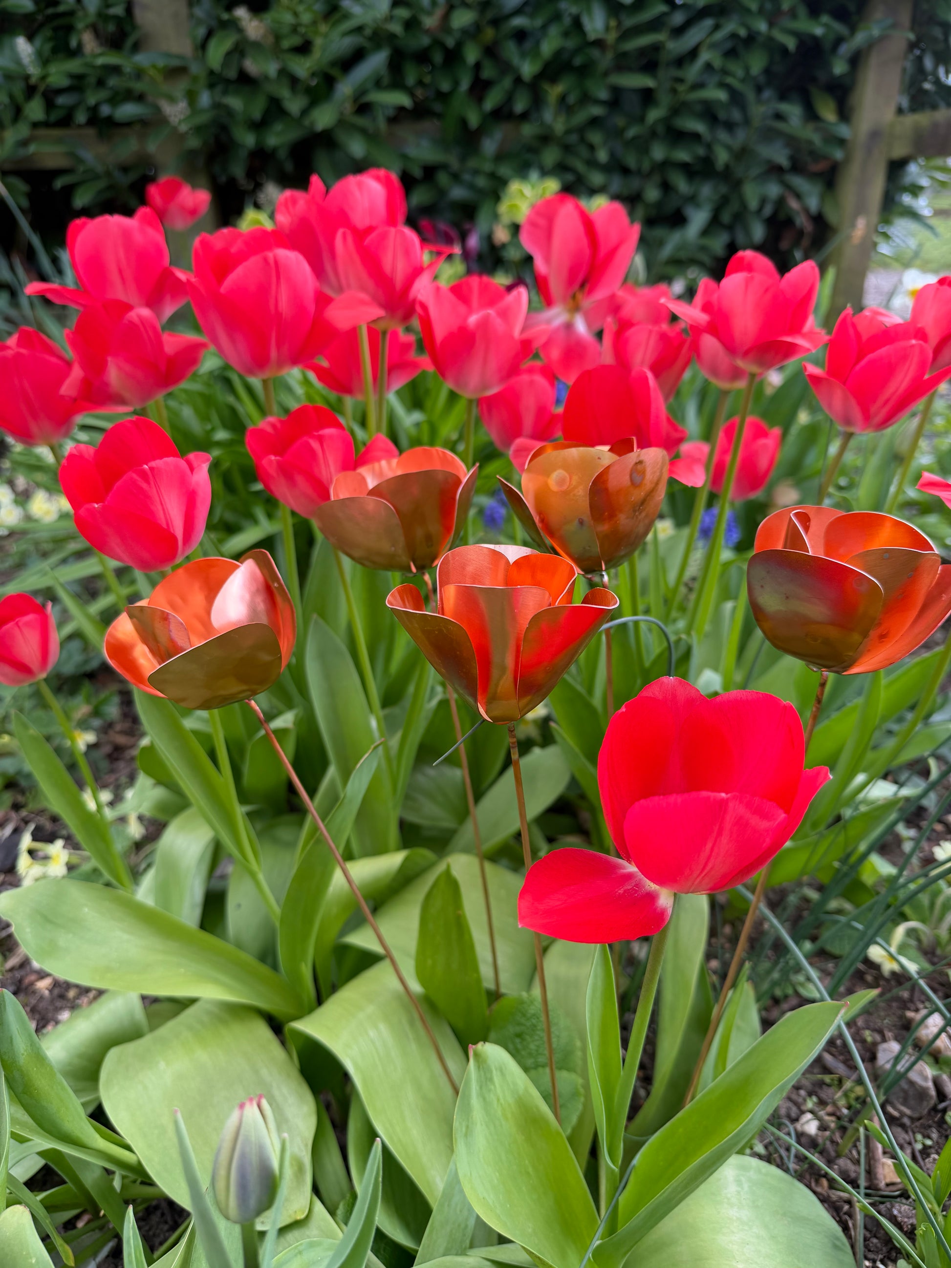 Red tulips with a copper metal sculpture of a tulip in the center from Copper and Green