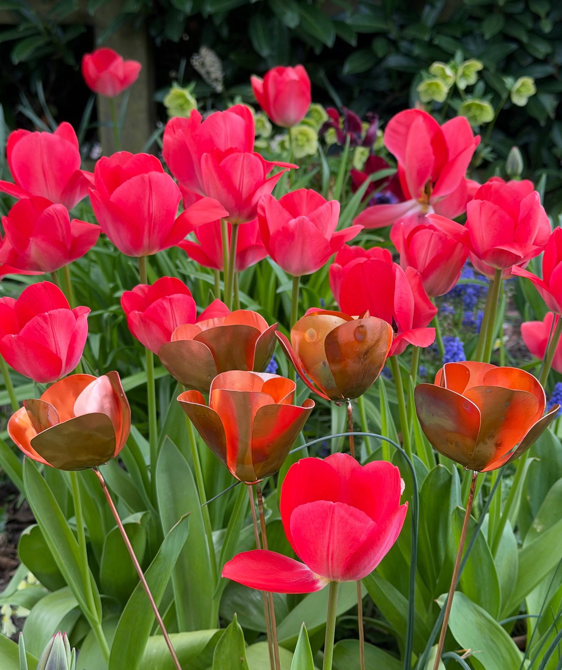 Red tulips with a copper metal sculpture of a tulip in the center from Copper and Green