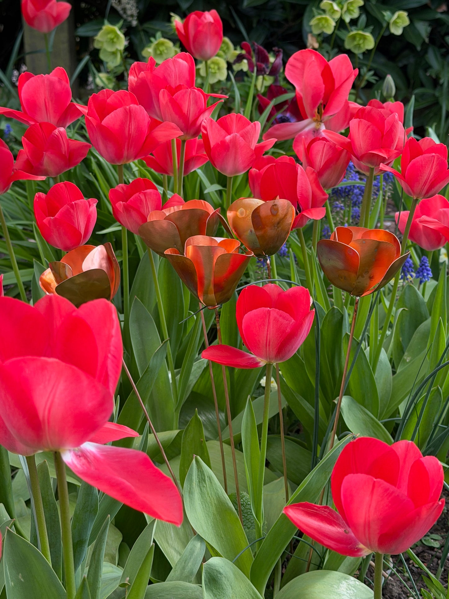 Red tulips with a copper metal sculpture of a tulip in the center from Copper and Green