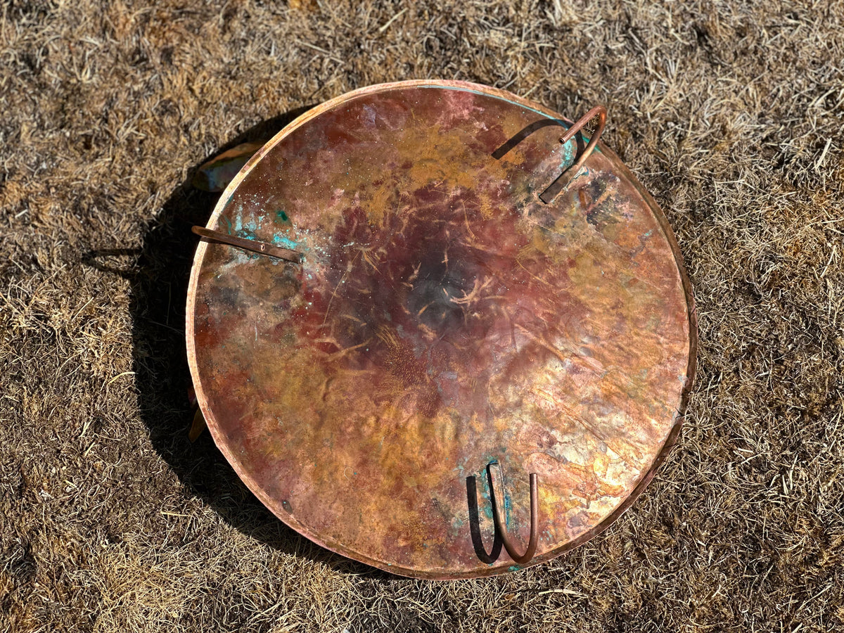 Bottom of Hand made Copper and Green Hammered copper bowl ground level/floor standing bird bath with verdigris leaves.